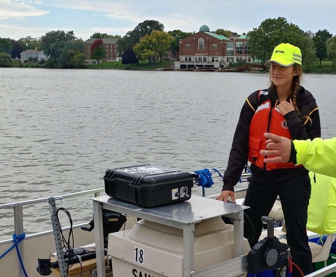 Engineer steering boat on waterway