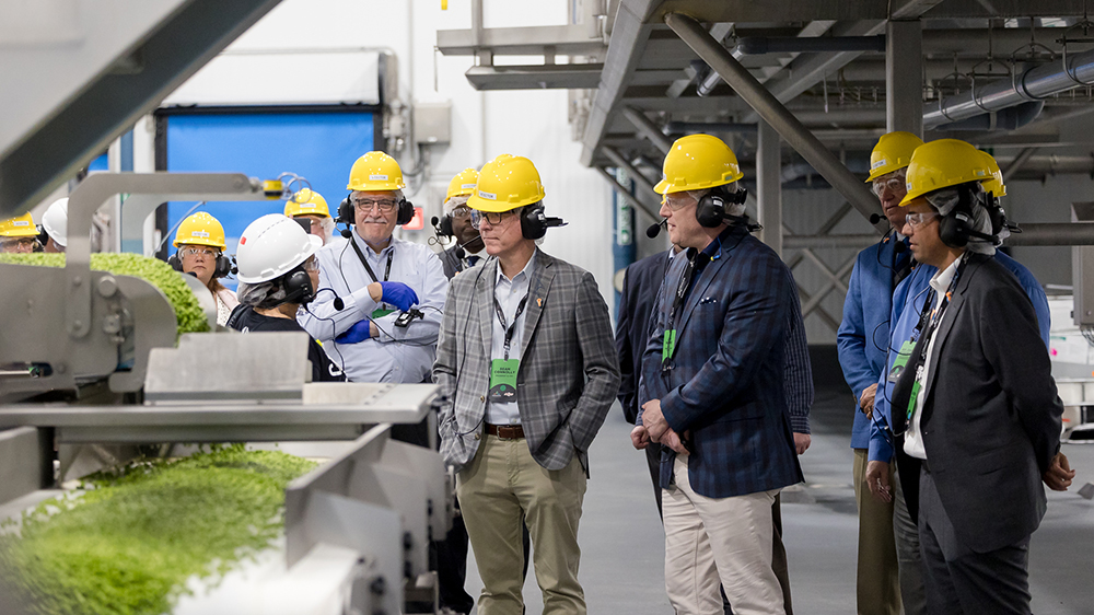 People in hardhats touring Conagra facility