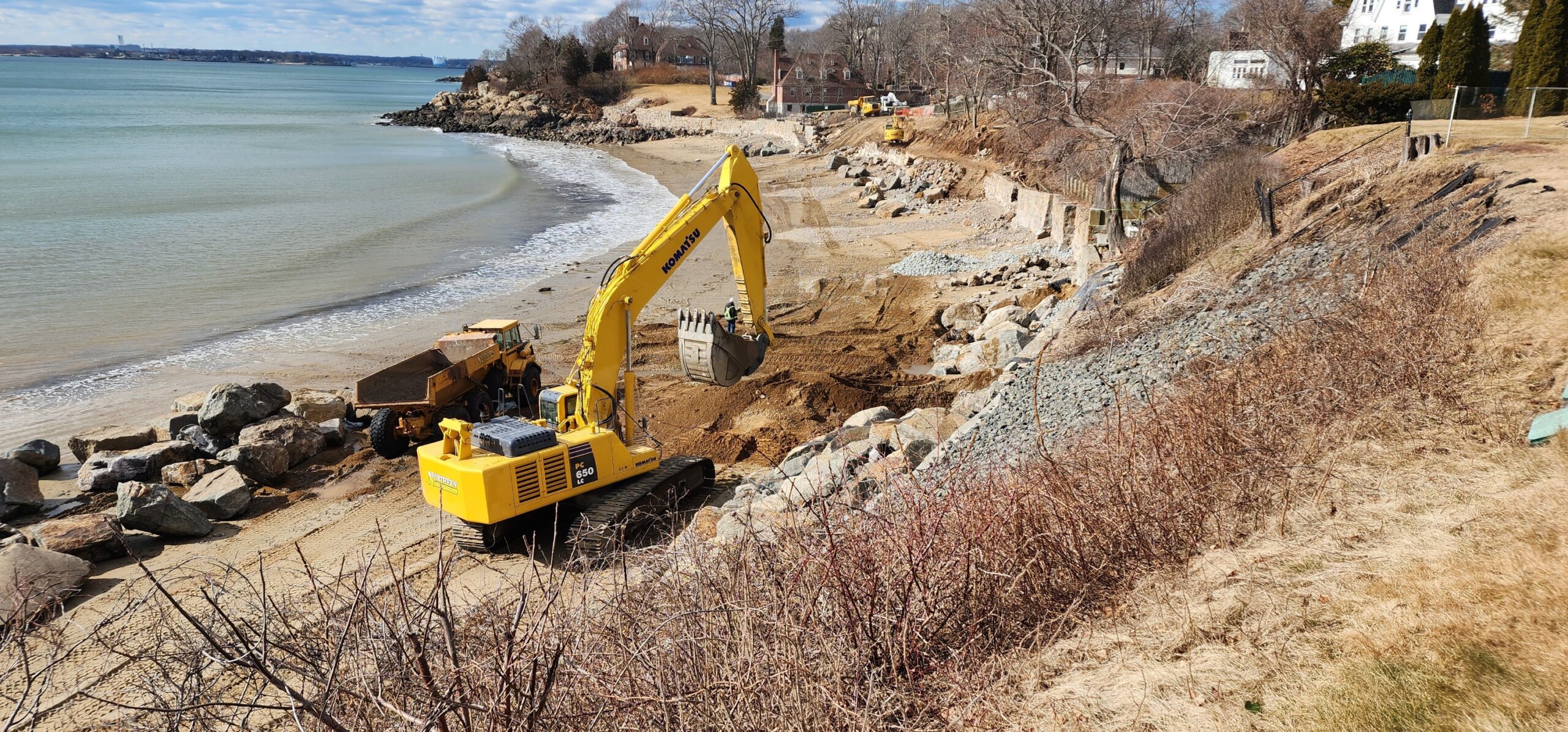 Construction equipment along coast for seawall project
