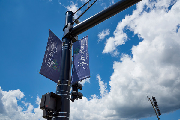 Ground level view of streetlight arm with city banner.